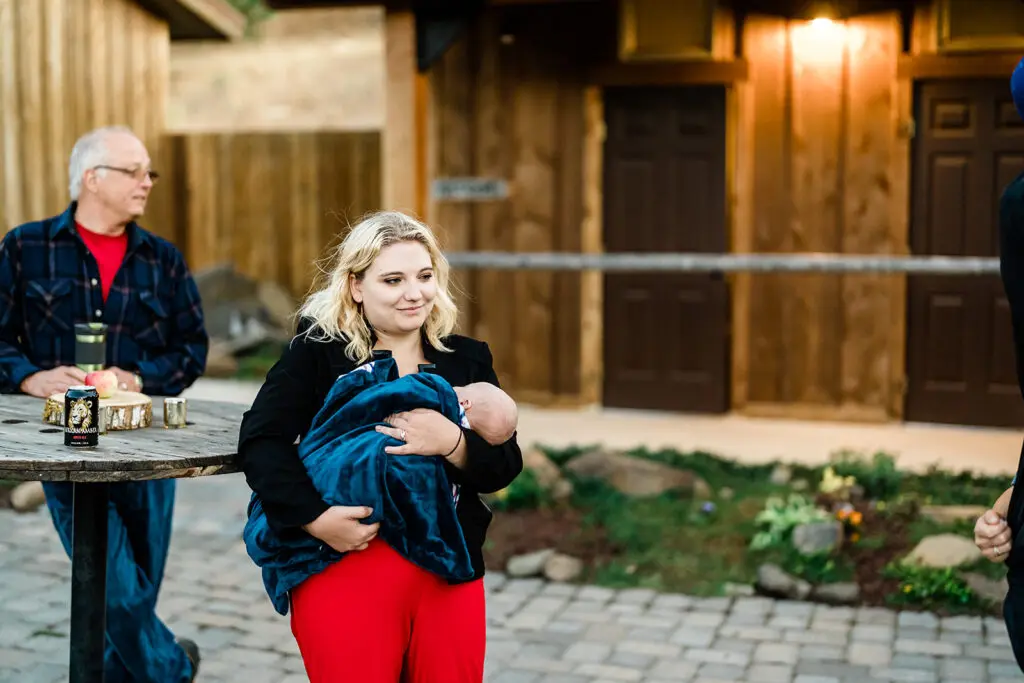 Guest and her baby at a Cattle Barn Wedding