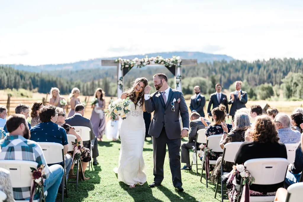 Bride and Groom walking down the isle Cattle Barn Wedding down the isle at a