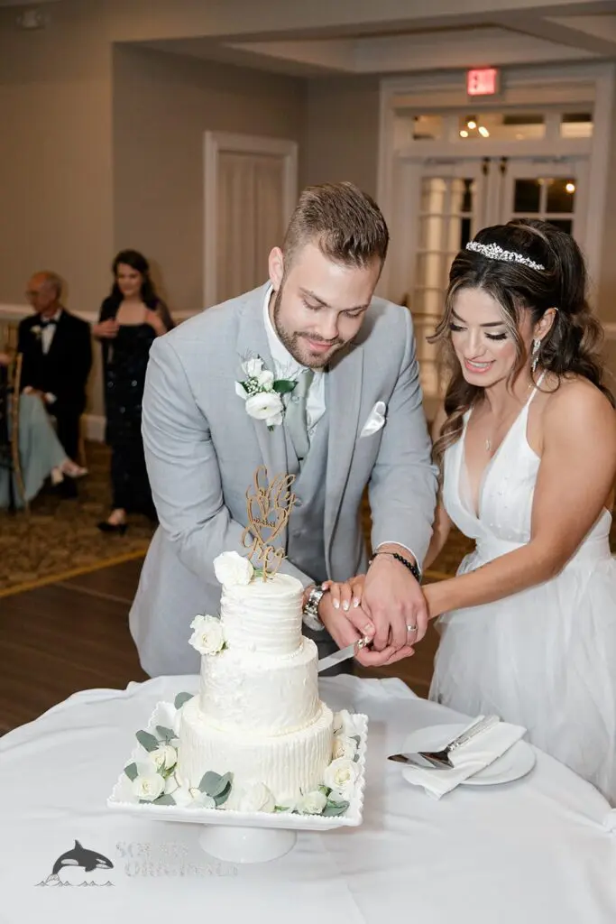 Bride and groom cut the cake at their Royal Melbourne Country Club Wedding reception