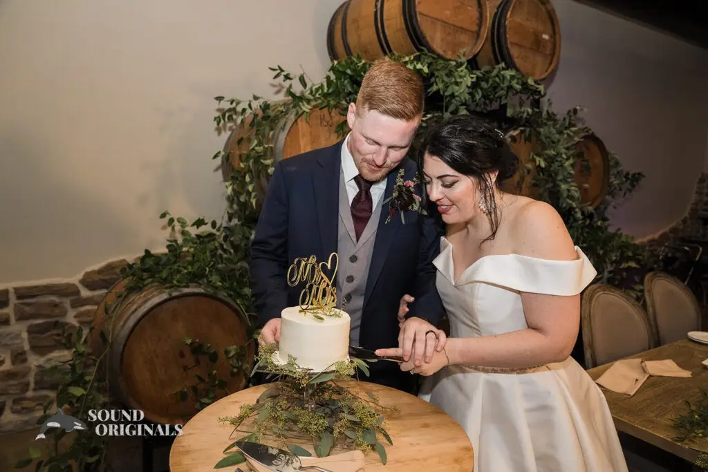 Newlyweds slicing their cake at Folino Estate Winery