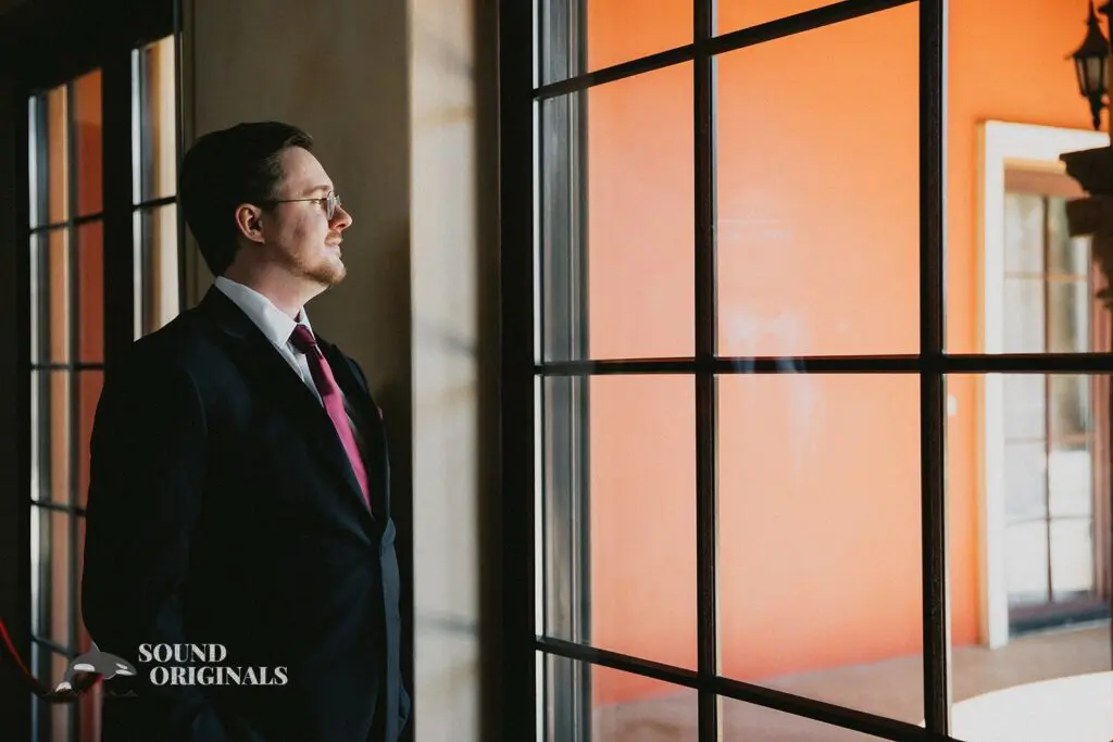 Wedding photographer captures pensive groom at Stoney Ridge Villa Wedding