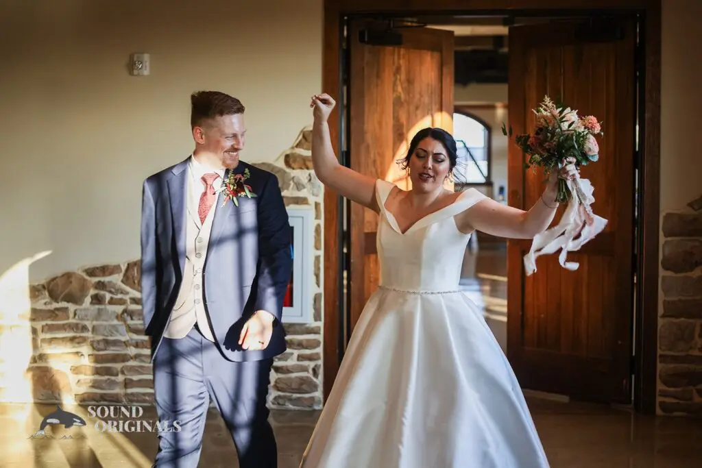 Groom grinning at his dancing bride at Folino Estate Winery