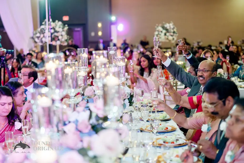 Guests raising a toast to the bride and groom at their Embassy Suites by Hilton Naperville Wedding reception