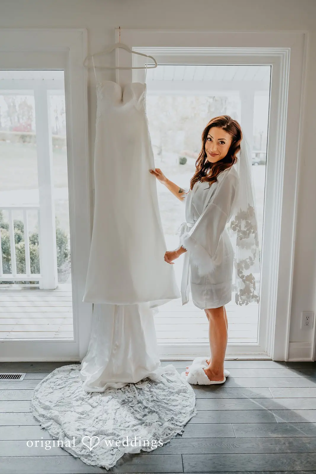 Kamaria + Chris A stunning portrait of the bride beside her wedding gown