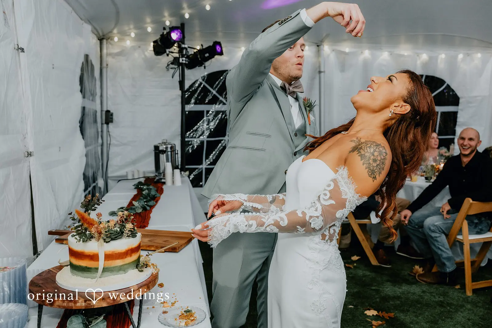 Kamaria + Chris The bride and groom having a fun-filled moment after their cake cutting