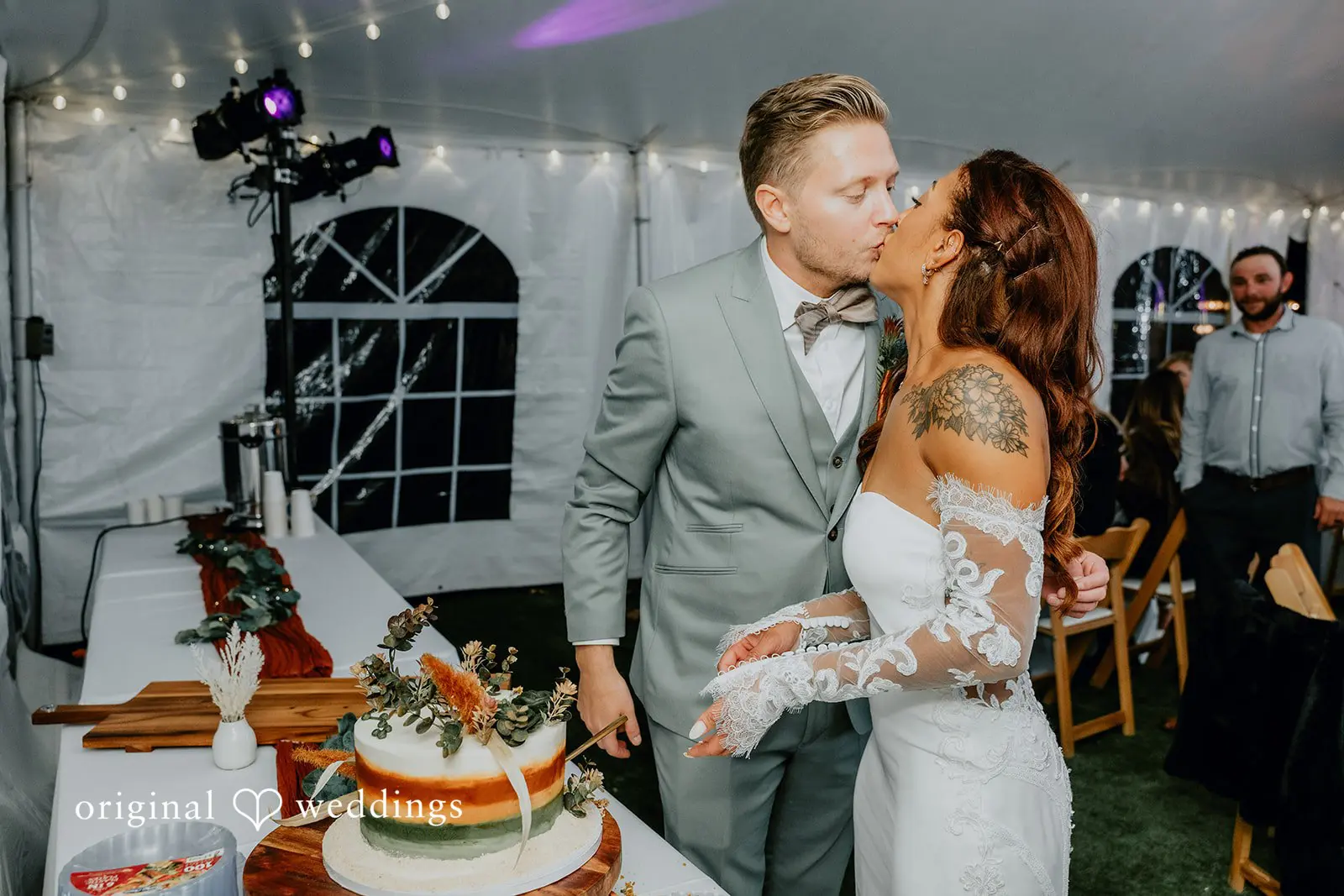 Kamaria + Chris The bride and groom seal their cake cutting with a kiss