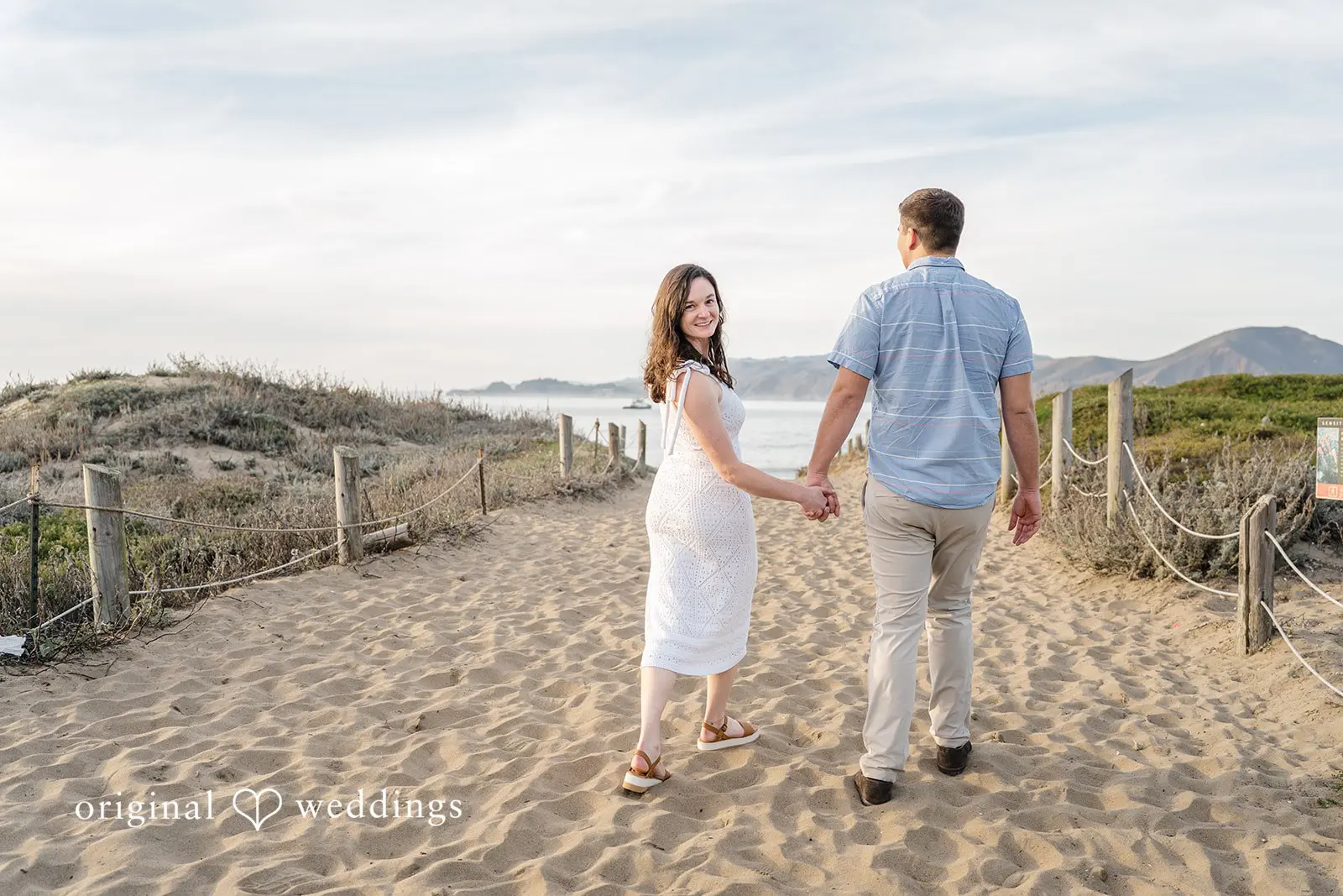 Daniel + Karen A stunning photo of the couple walking to the beach at Baker Beach