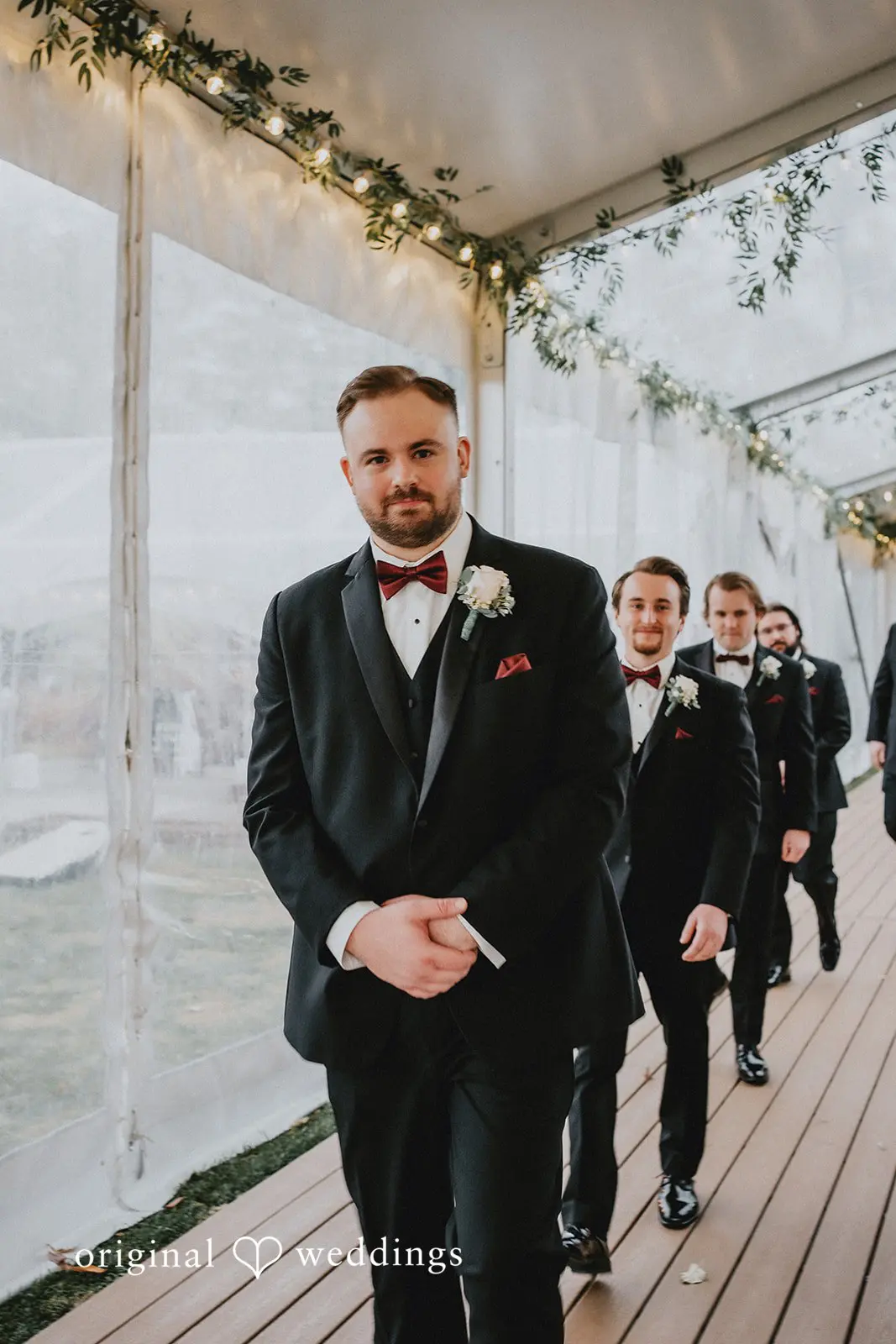 Stephanie + Zachary A portrait of the groom and the groomsmen walking down the ceremony space