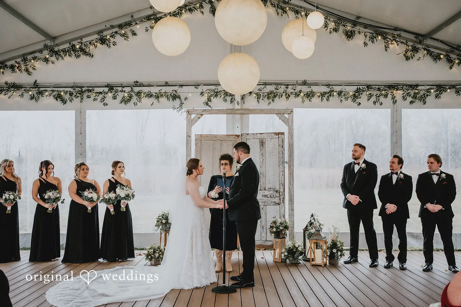 Stephanie + Zachary The groom and bride exchanging marital vows at Bishop Farmstead