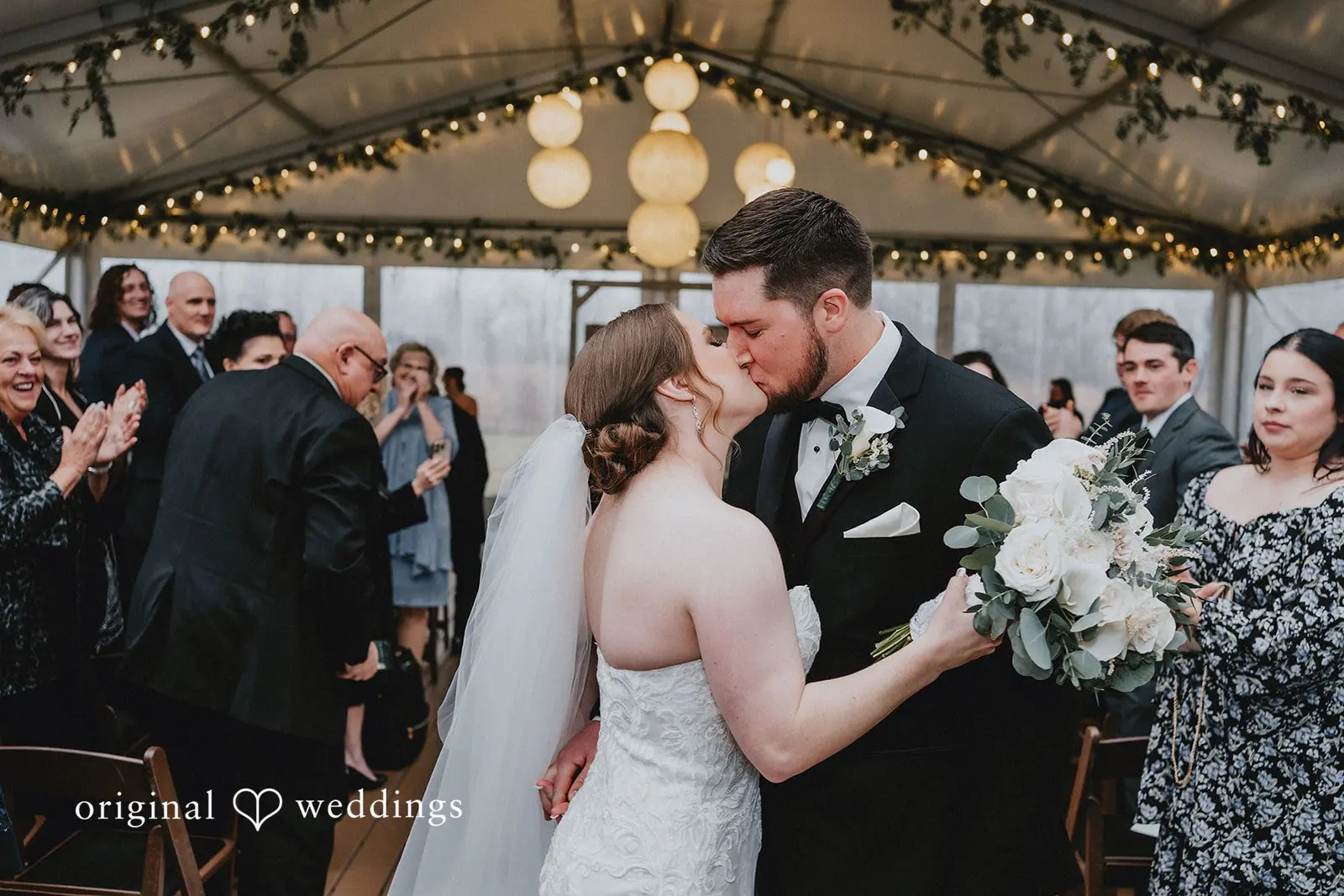 Stephanie + Zachary The bride and groom share a kiss after their wedding ceremony