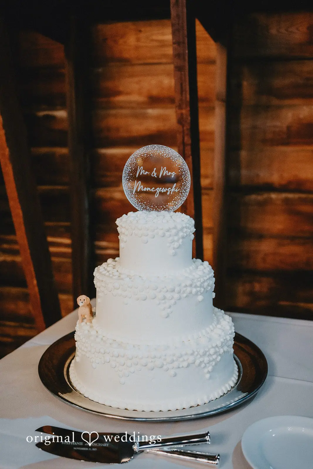 Stephanie + Zachary An all-white cake at the wedding reception