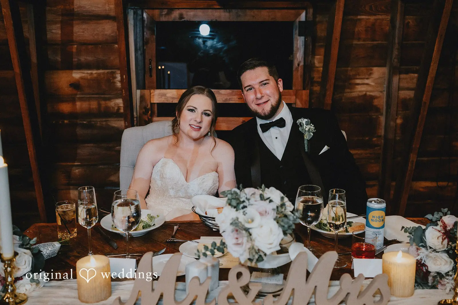 Stephanie + Zachary The bride and groom seated pretty at their wedding reception
