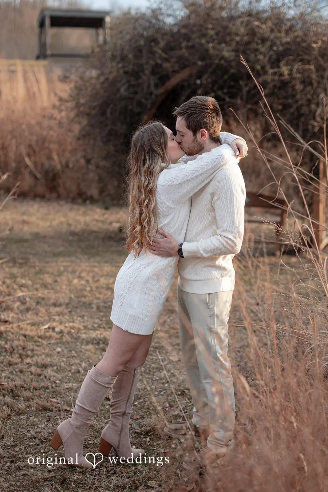 Rosemary + James The couple shares a romantic kiss at the park