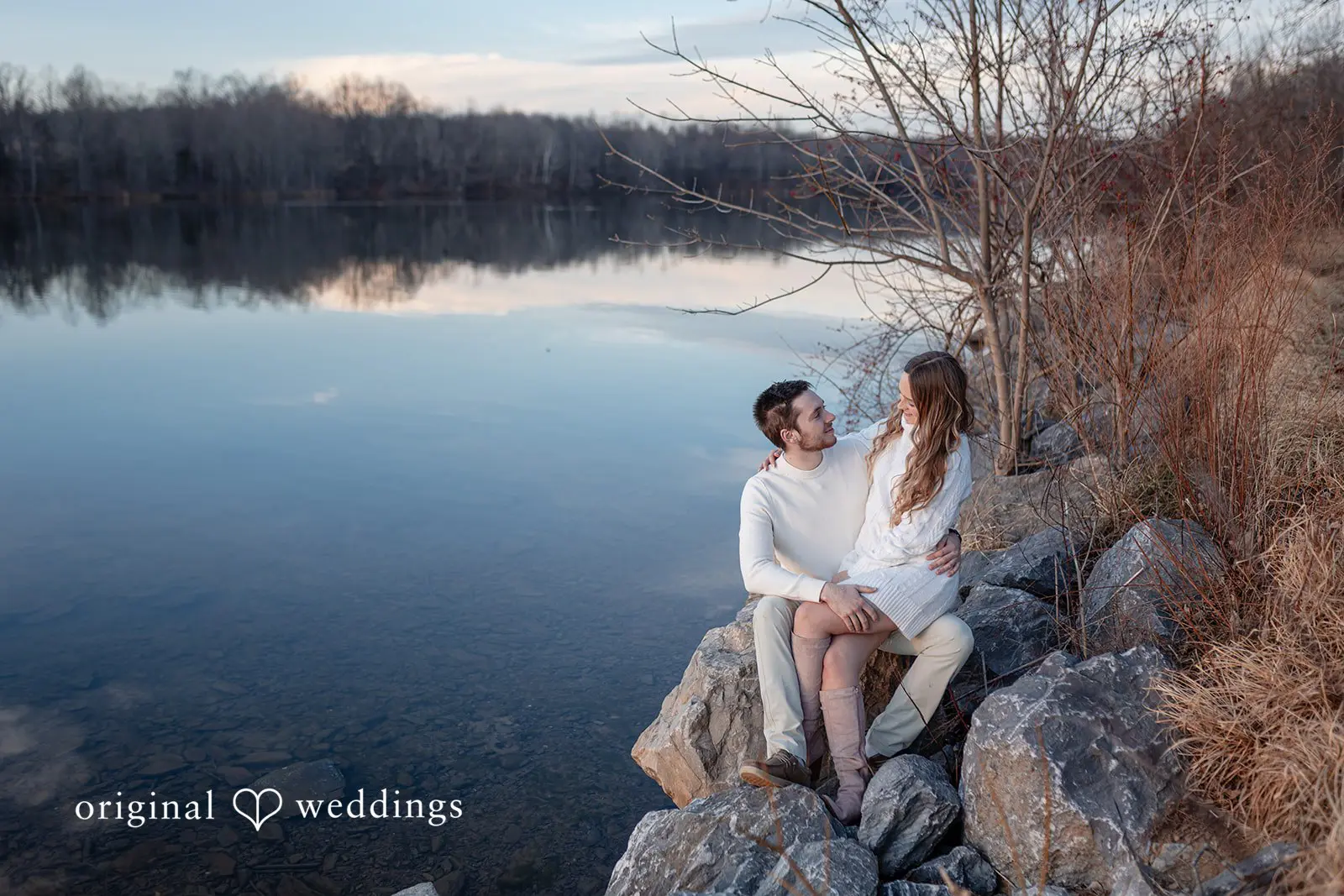 Rosemary + James A romantic portrait of the couple seated by the waterfront