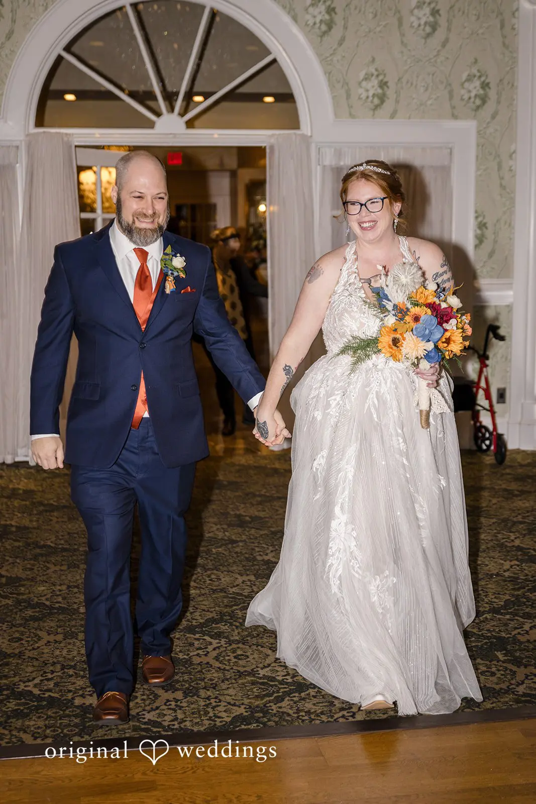 The bride and groom make a happy entrance into the Buck Hotel's reception