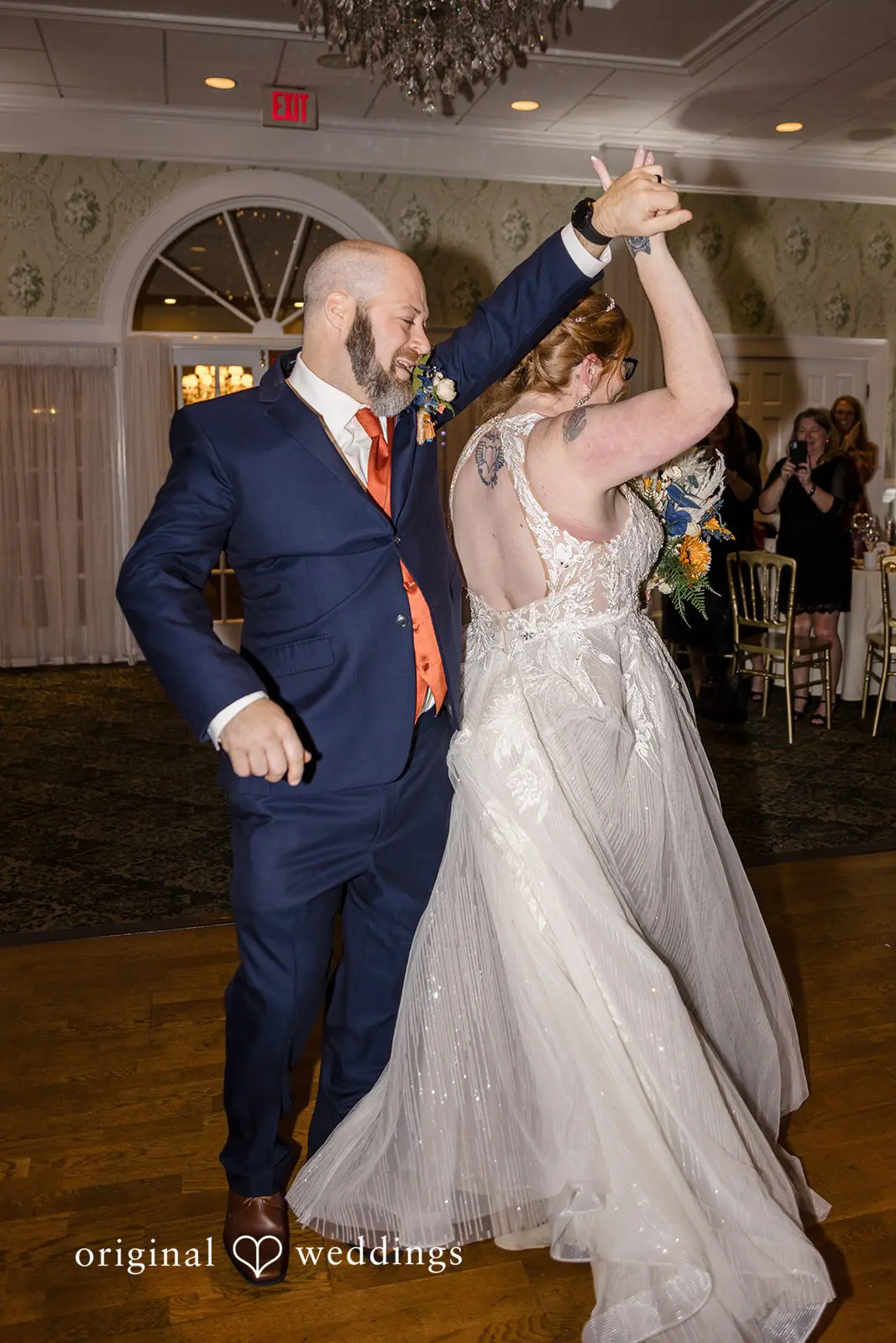 The bride and groom are having their first dance at the Buck Hotel's wedding reception