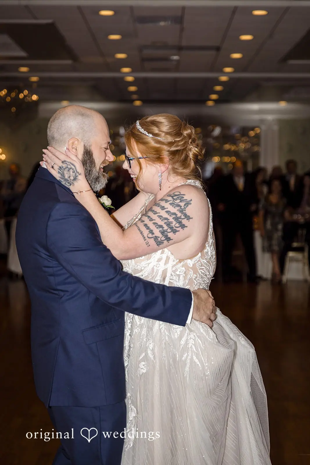A romantic and emotional moment the bride and groom hold each other in their reception
