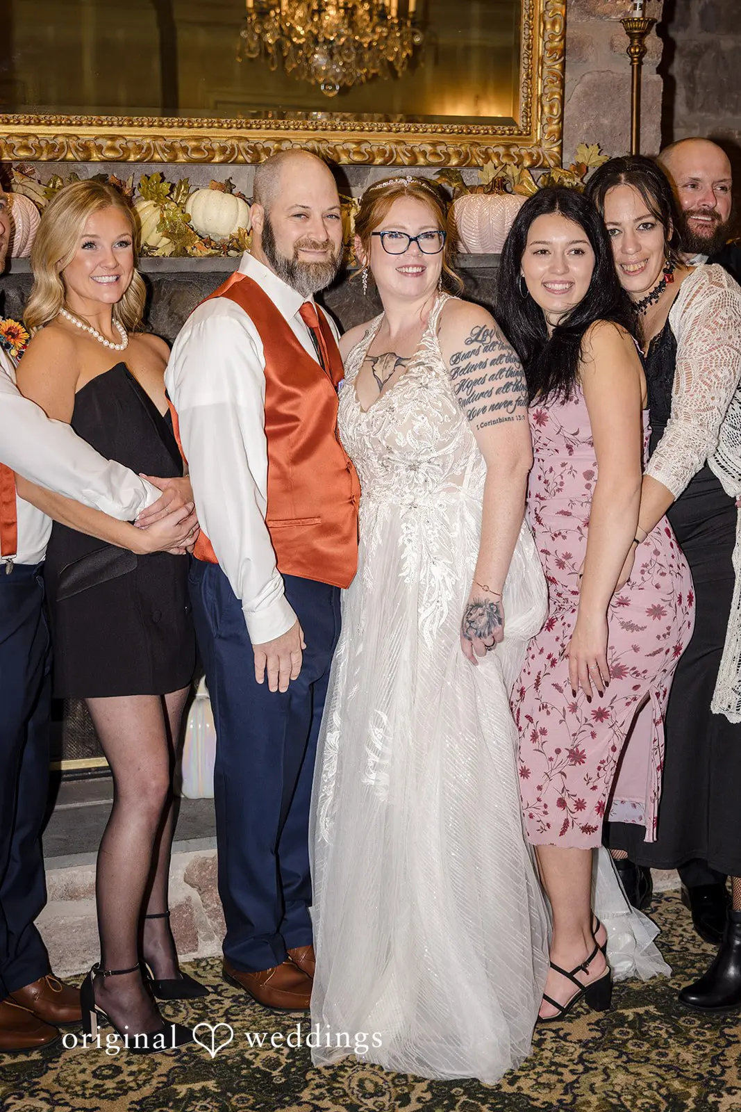 Beautiful portrait of the couple with some guests at the wedding reception