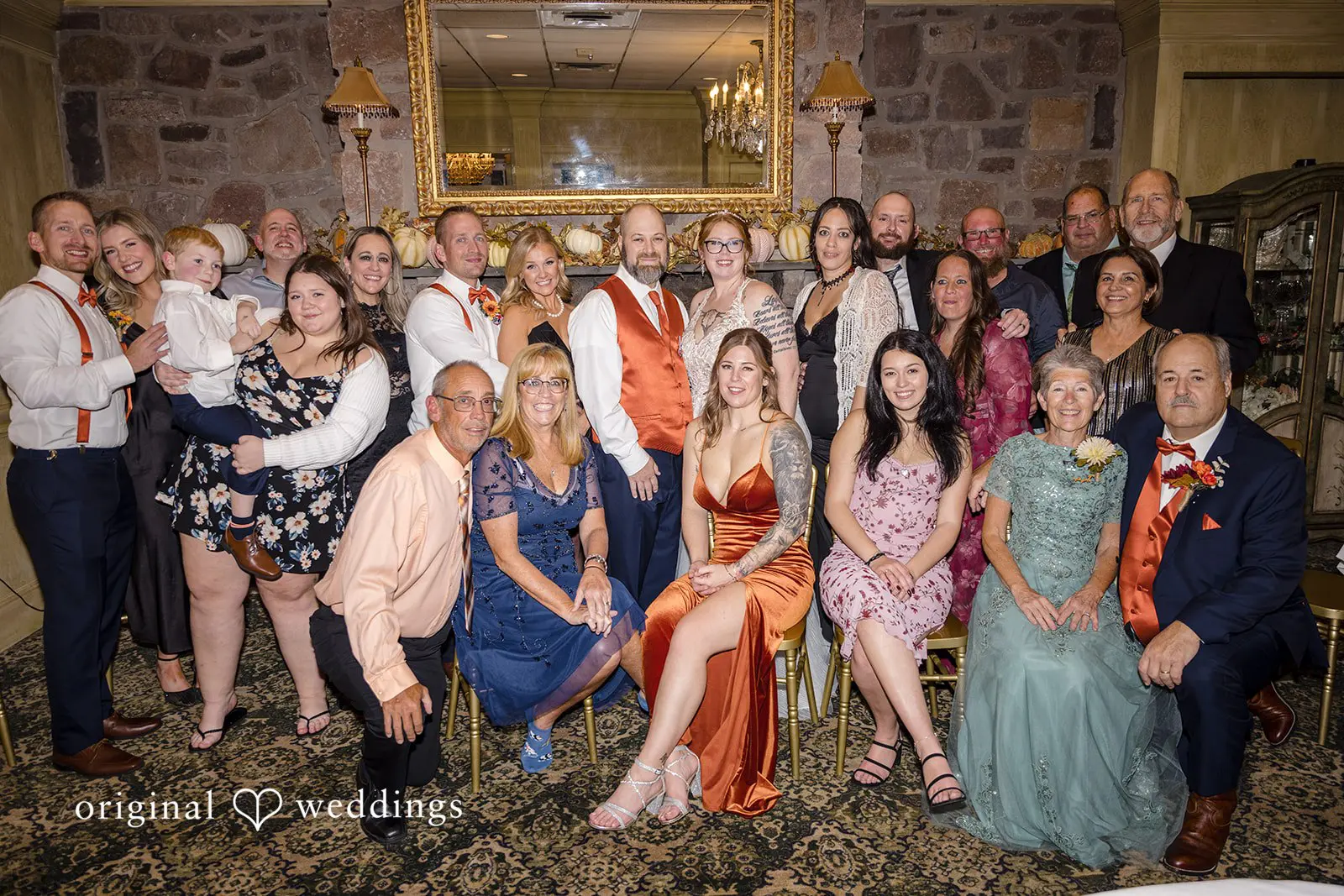 A portrait of the couple with family and friends