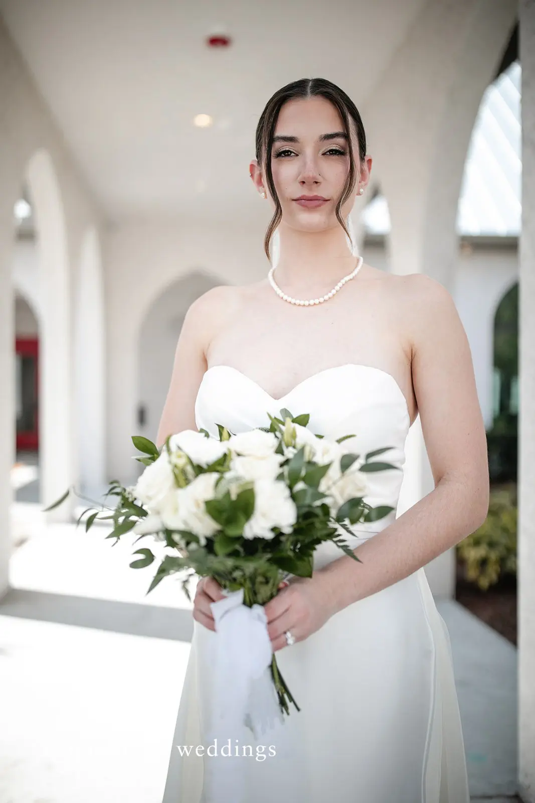 Stunning portrait of bride holding flowers at Canterbury Hall by Tampa Wedding Photography