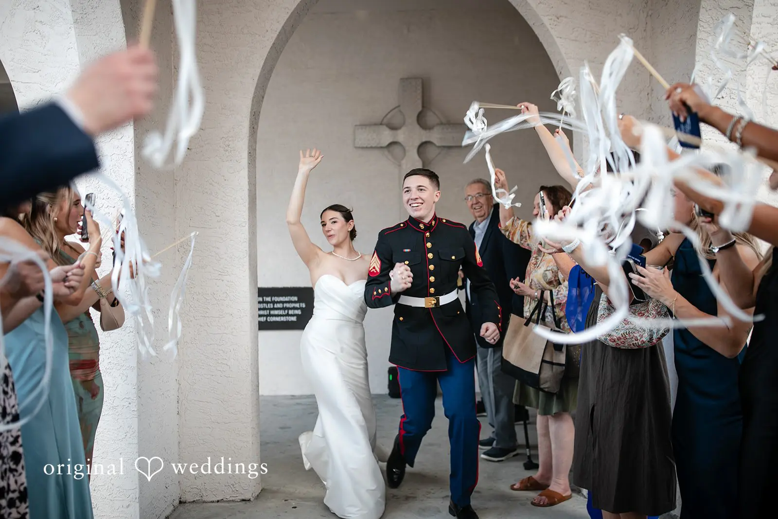 Newly married couple walking hand in hand , smiling and celebrating