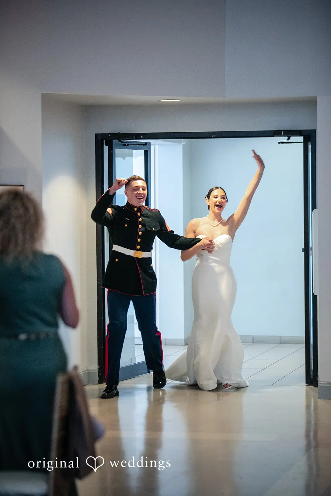 Couple entering for reception joyfully