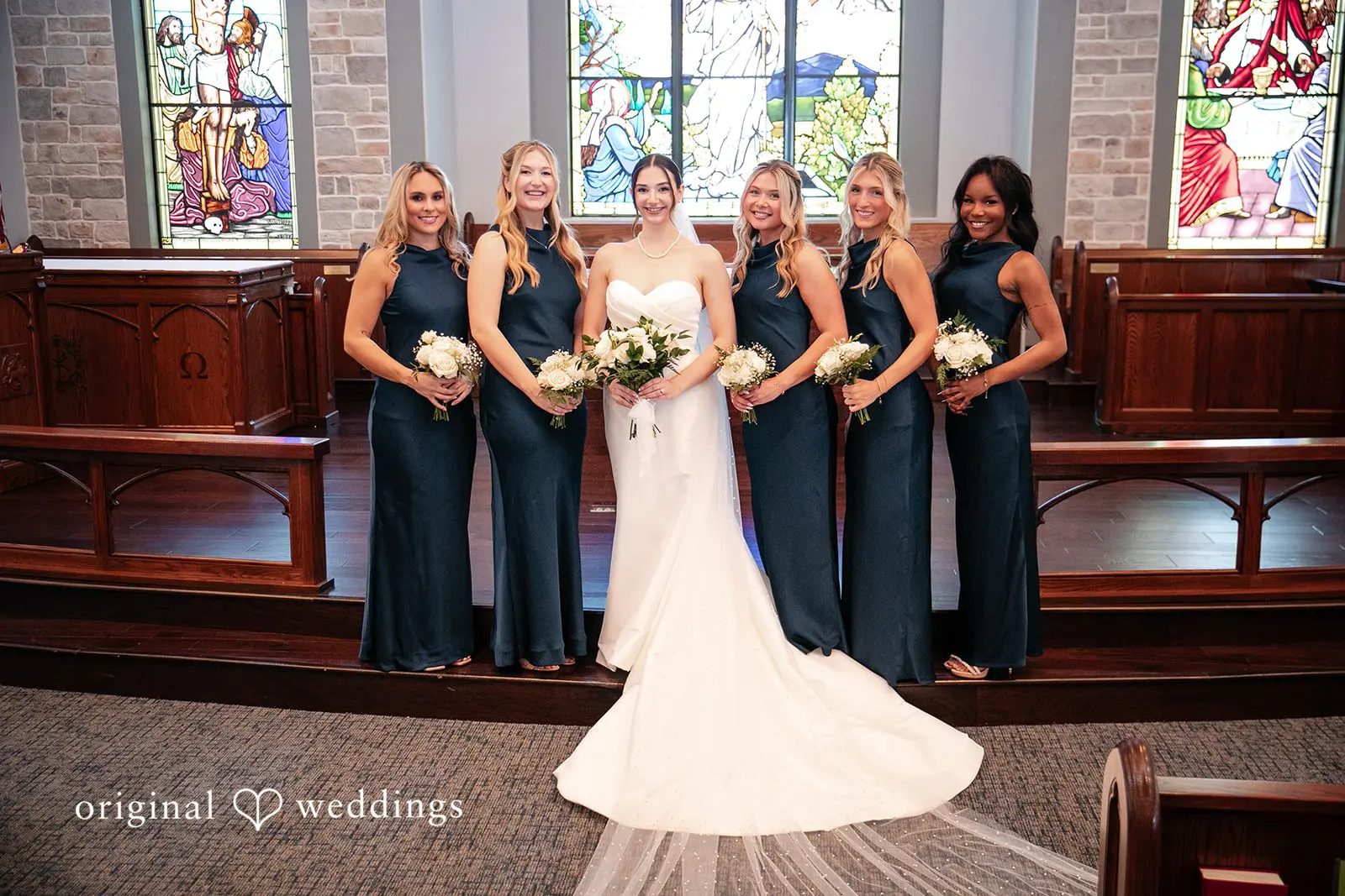 Bride and bridesmaids holding flower bouquets, standing together and smiling