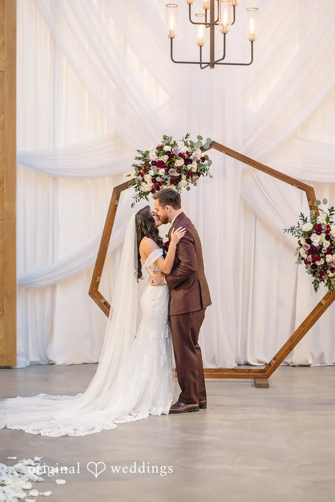 The bride and groom share their first kiss
