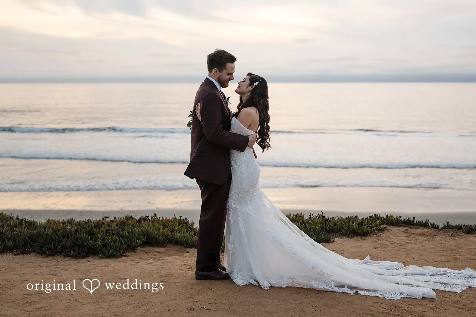 Our San Diego wedding photographer captured a romantic portrait of the couple at the waterfront near Carlsbad Windmill
