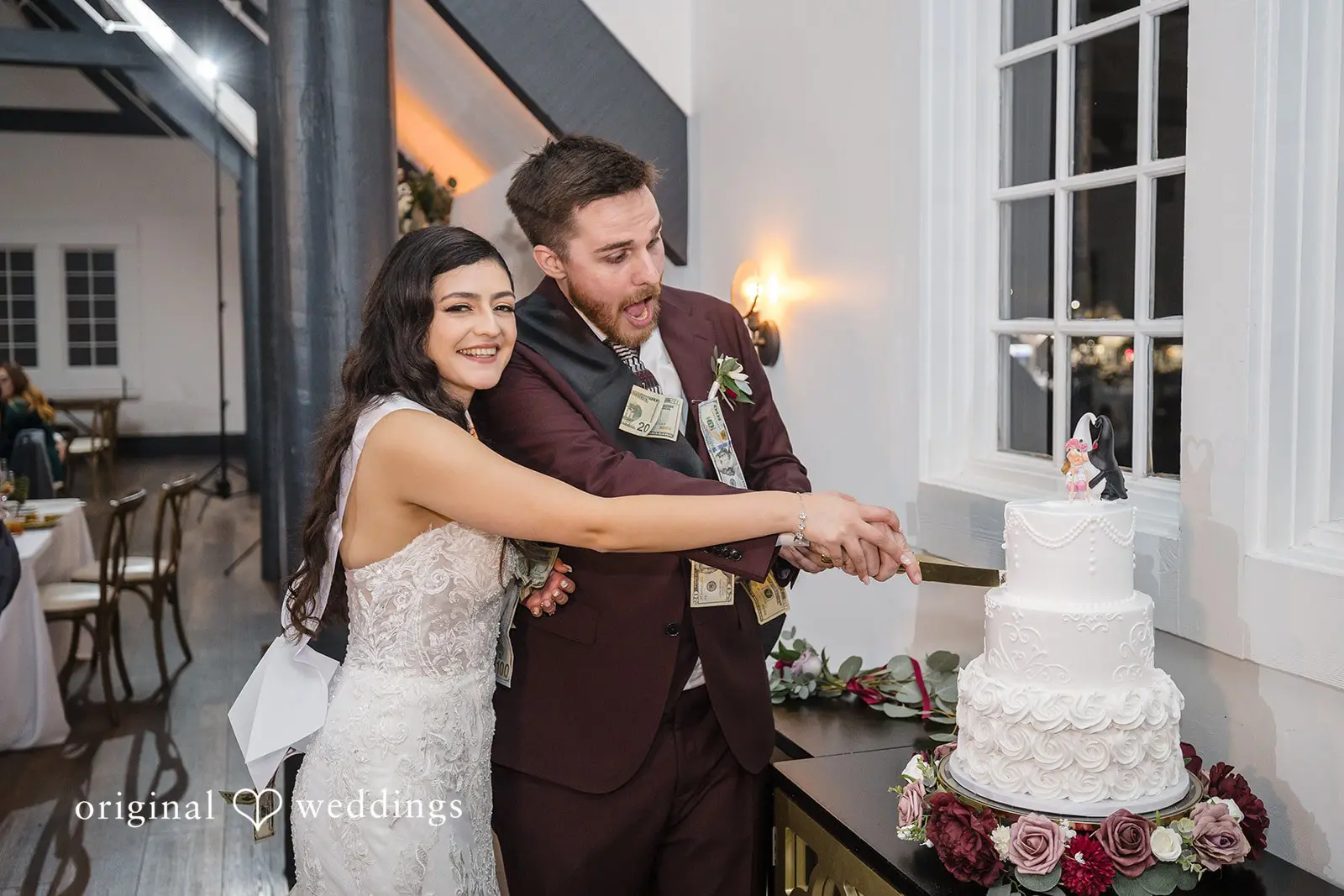 The couple cuts their cake at their wedding reception