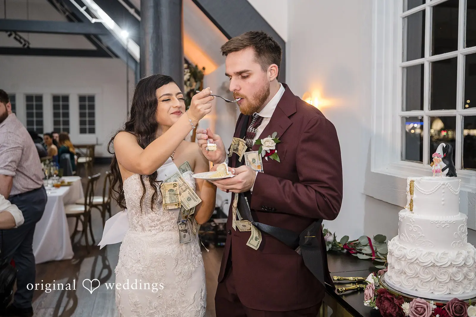 The bride feeds the groom cake at the wedding reception