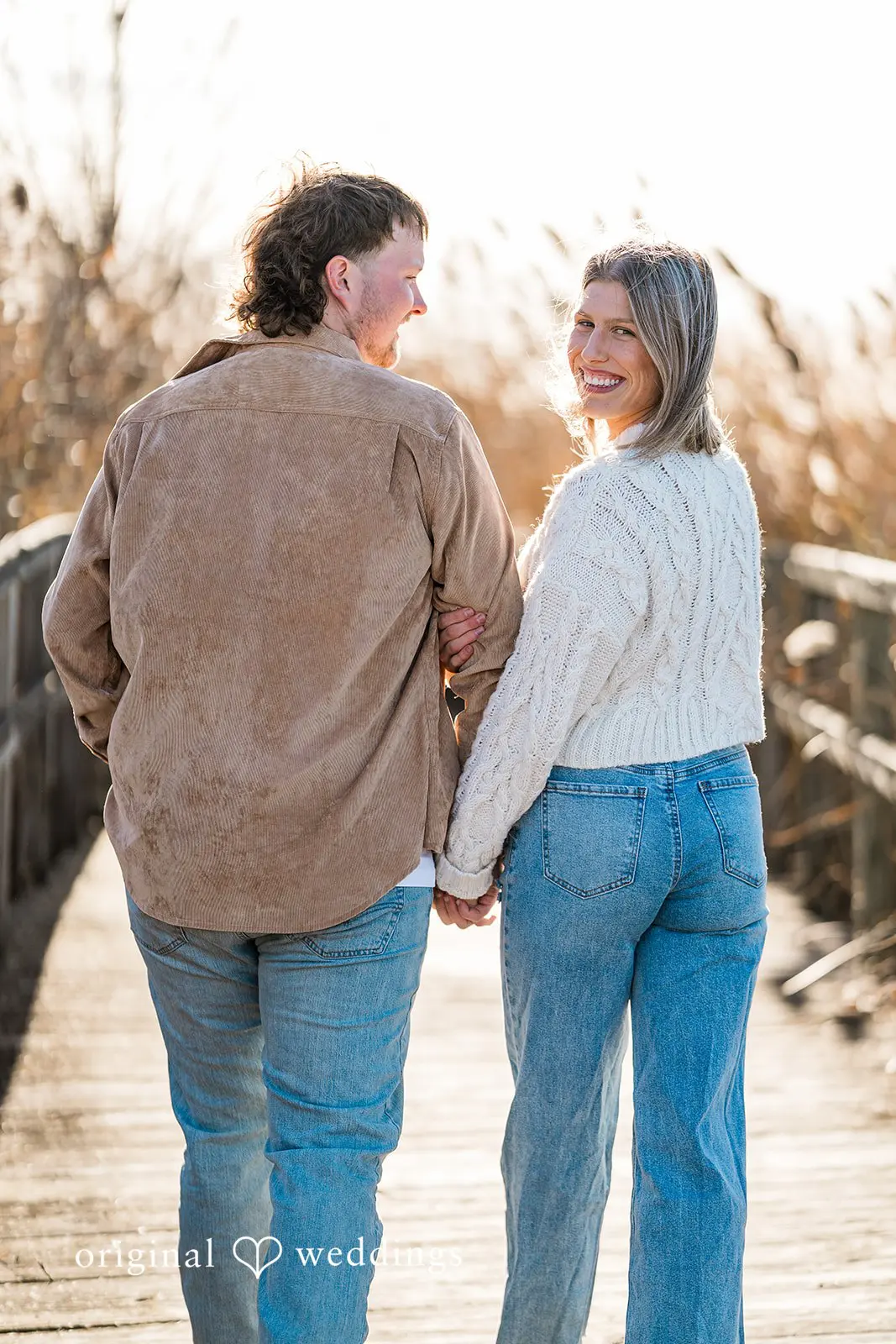 A back view portrait of the couple taking a walk at Crosswind Marshes