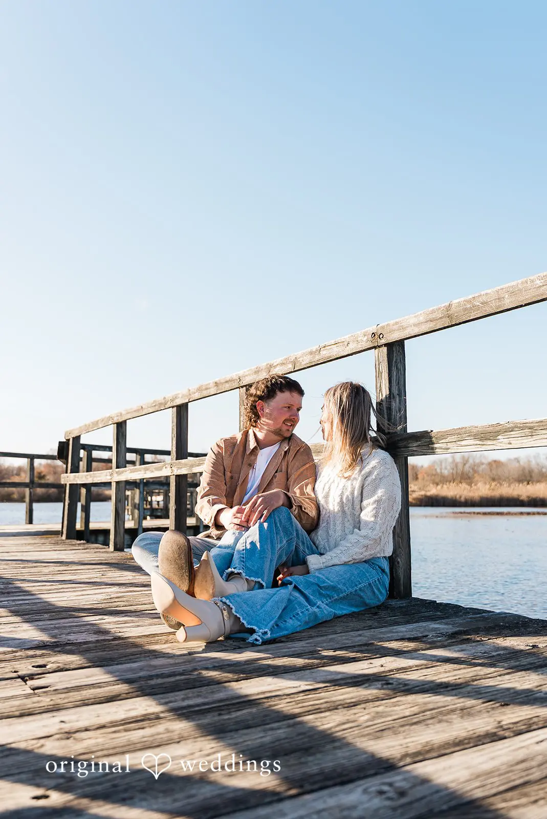 A portrait of the couple sitting on the trail