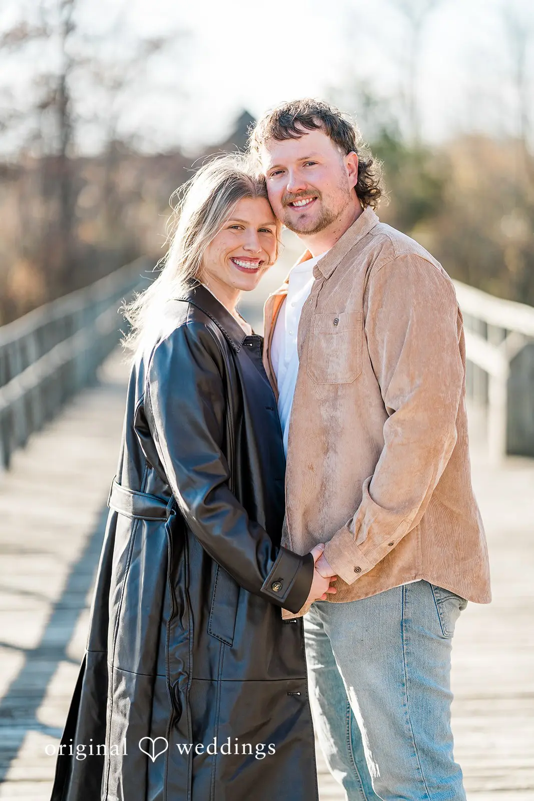 A close portrait of the couple holding hands at Crosswind Marshes