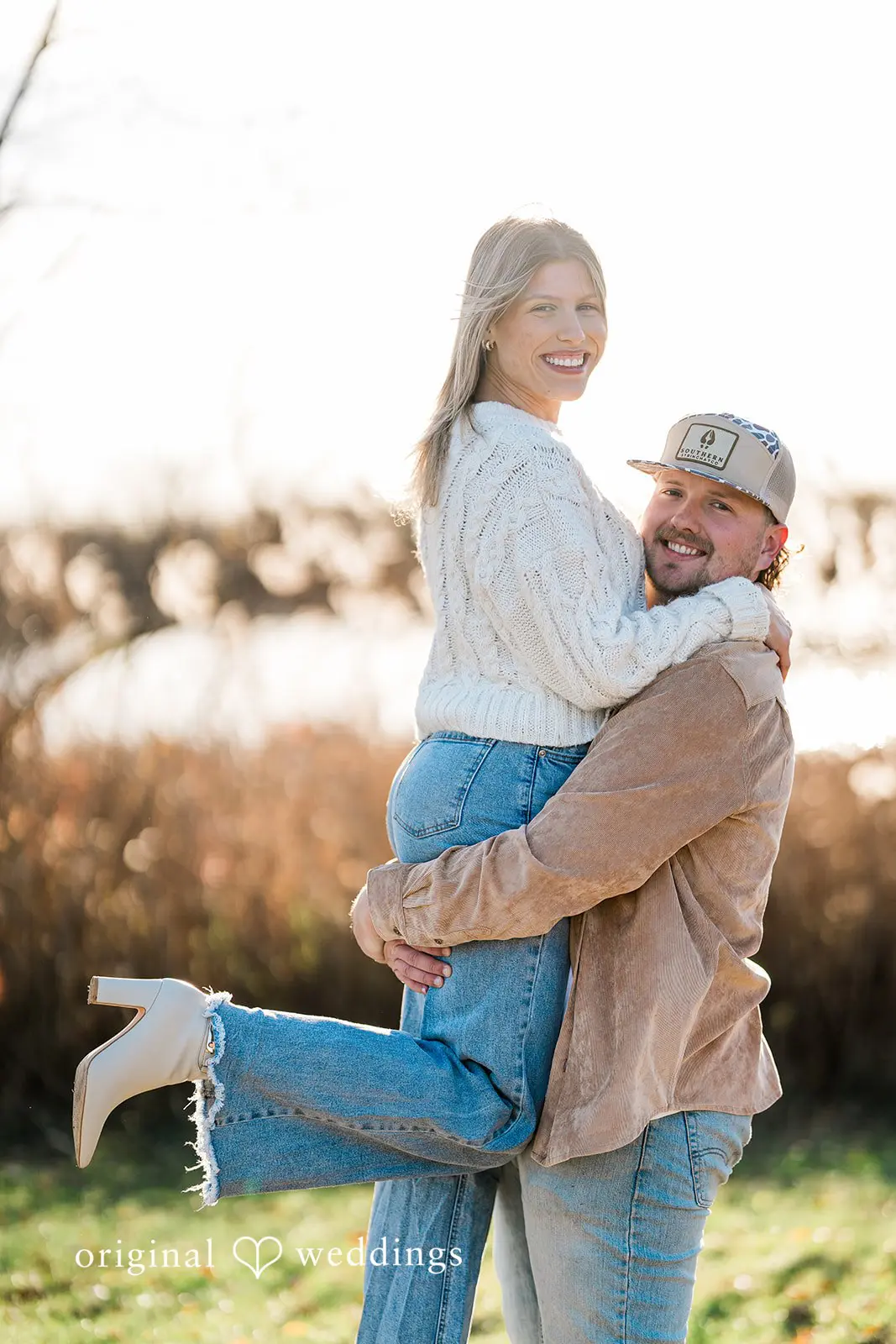 The groom lifts his soon-to-be bride up