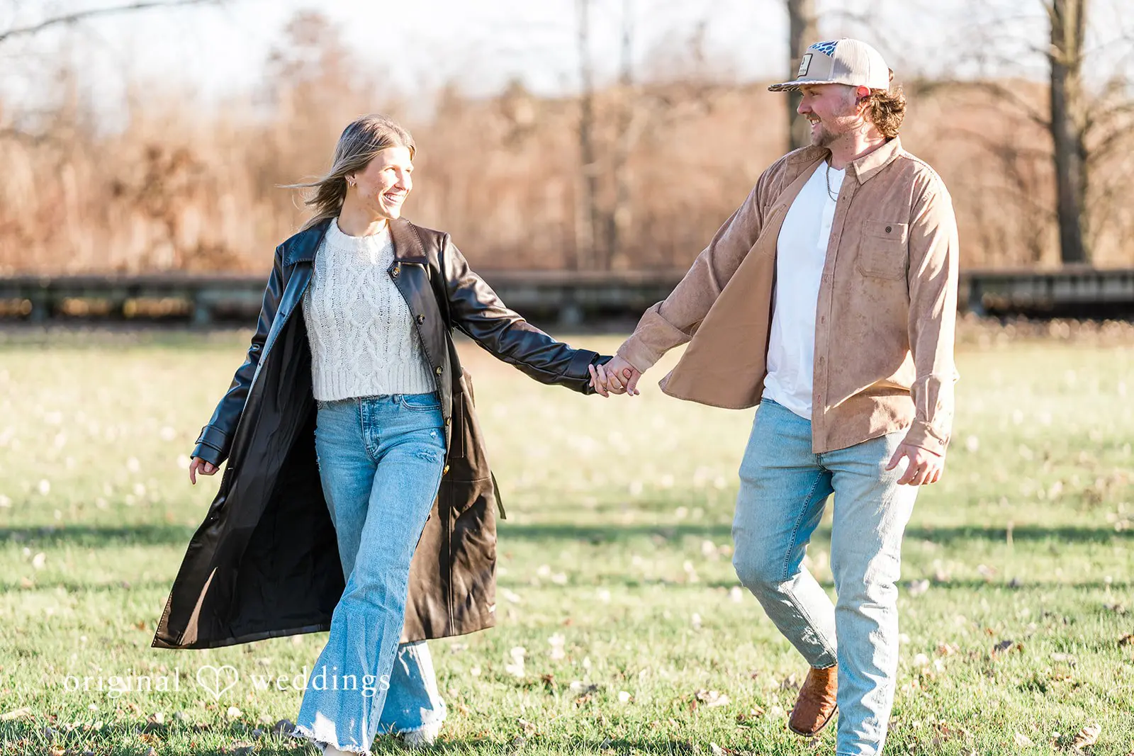 A portrait of the couple exploring the wide field at Crosswind Marshes