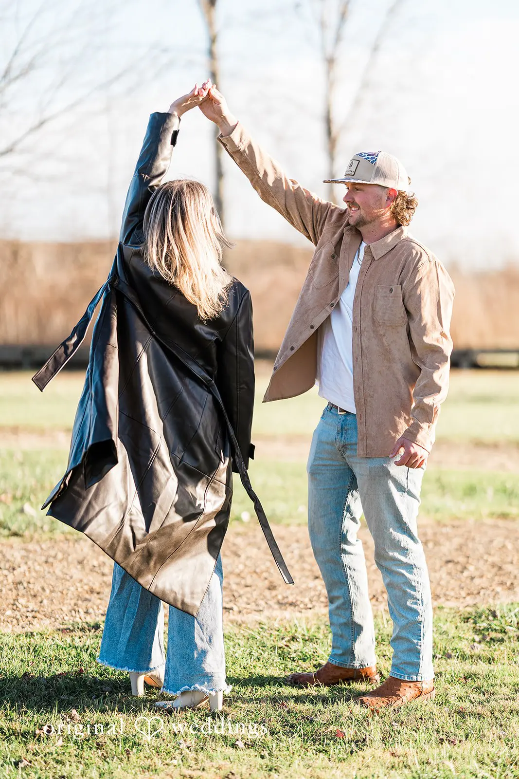 A fun time portrait of the couple at the field