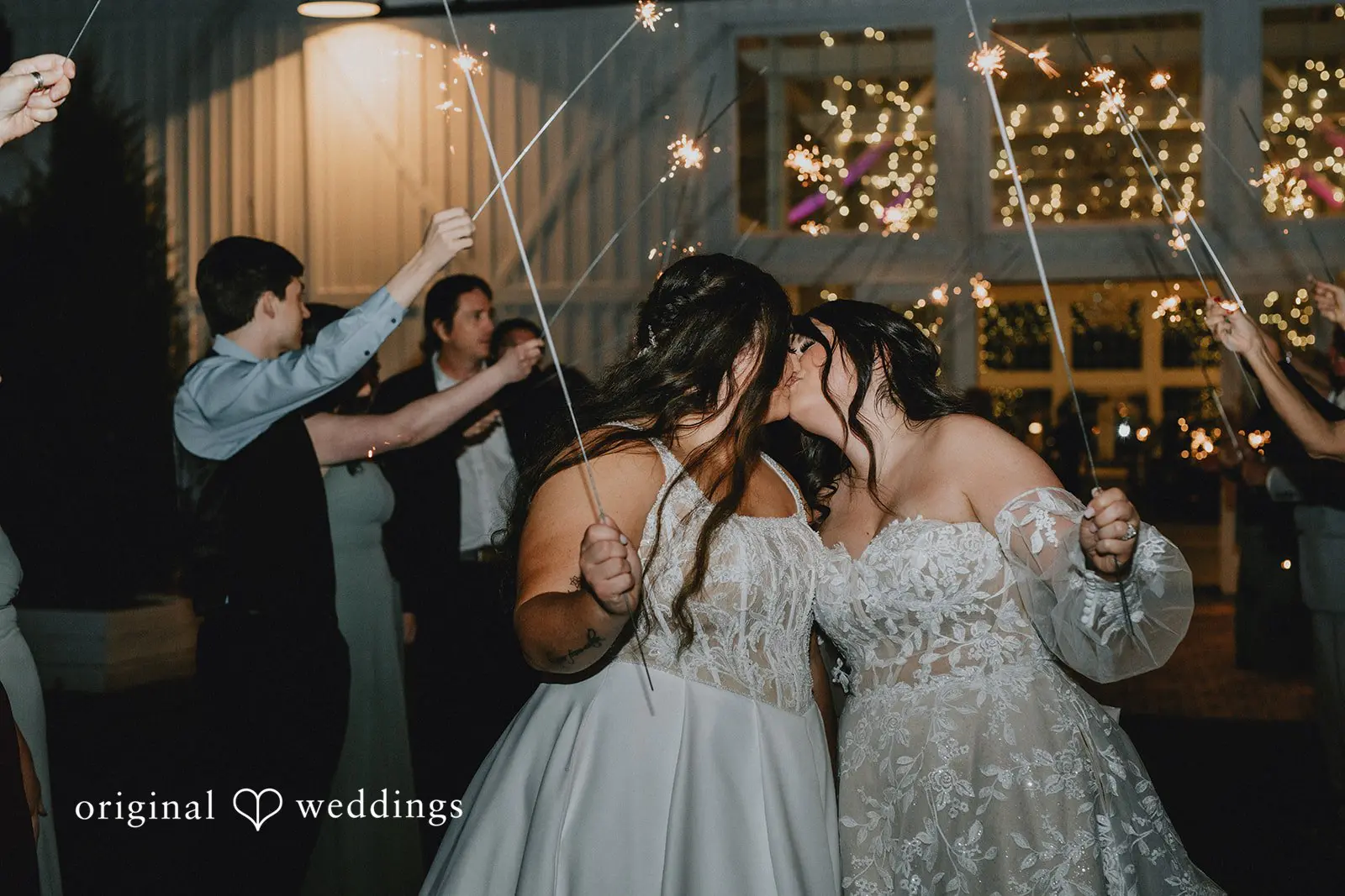Marisa + Jessica The couple seals their grand exit with a romantic kiss