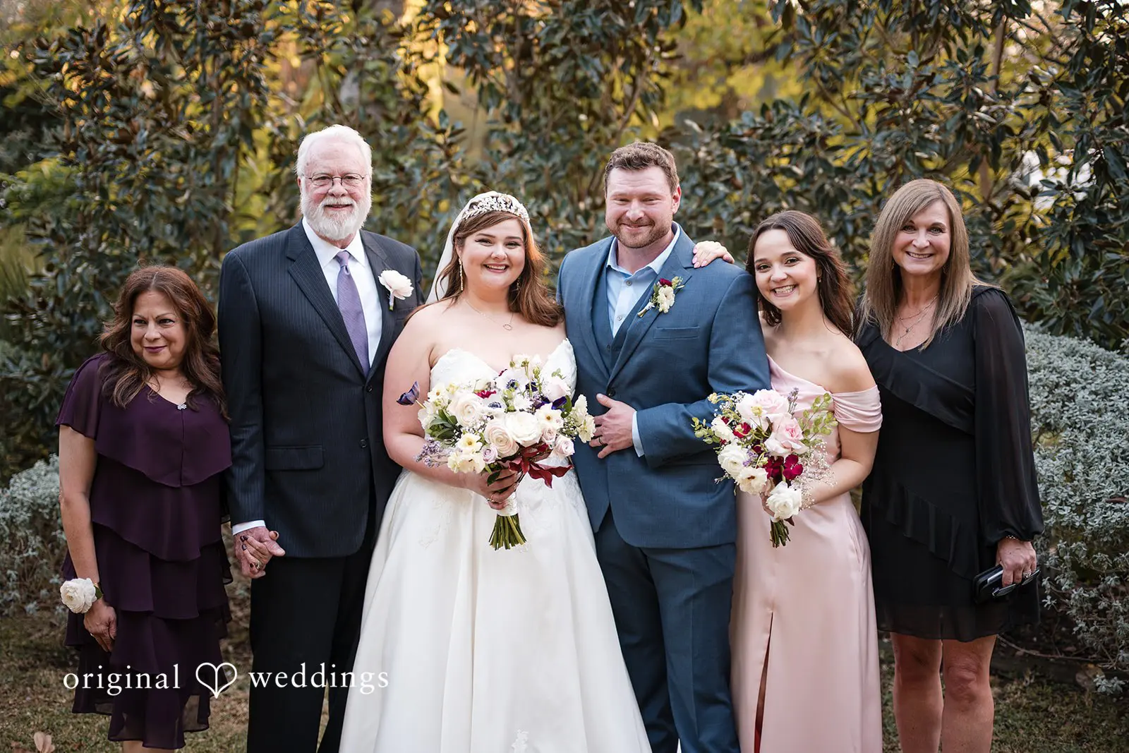 Ashley + David Our Austin wedding photographers took a beautiful portrait of the bride and groom with the family