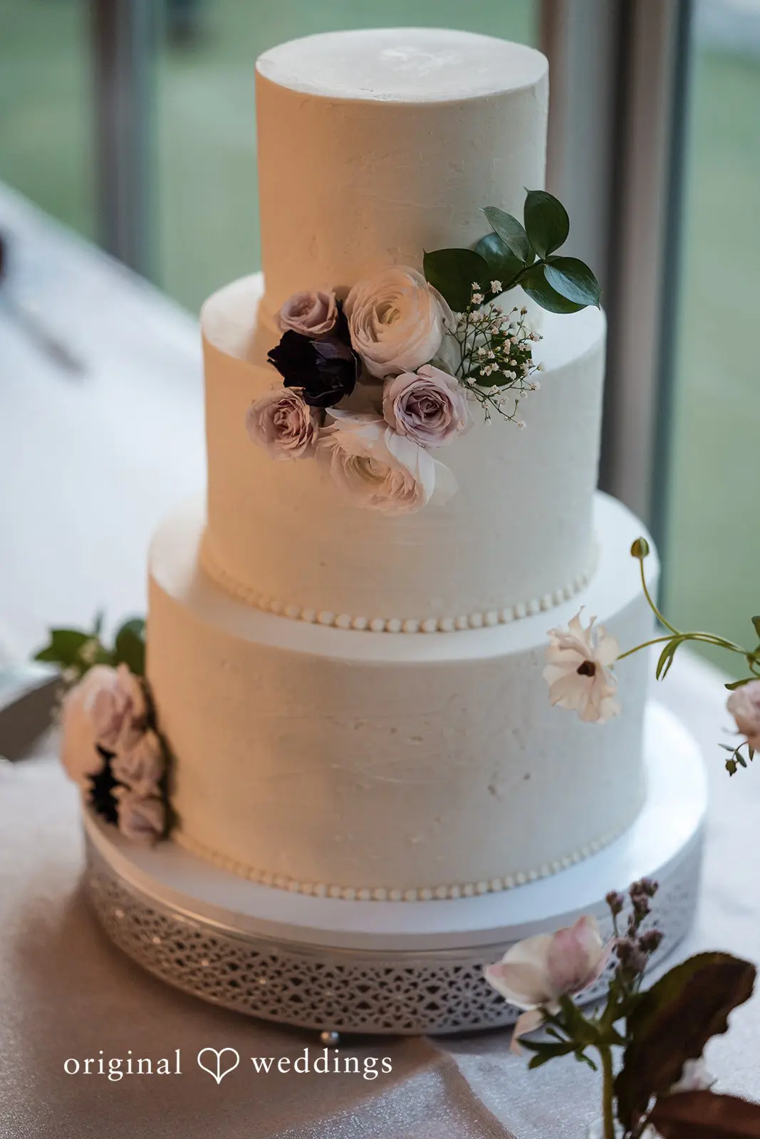 Ashley + David An all-white wedding cake with beautiful florals