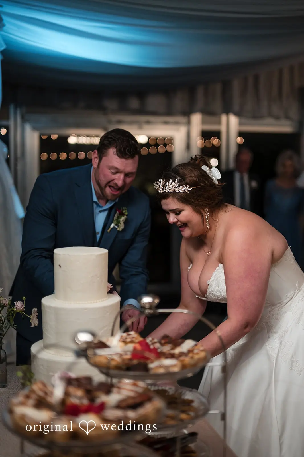 Ashley + David The bride and groom about to cut their cake at the wedding reception