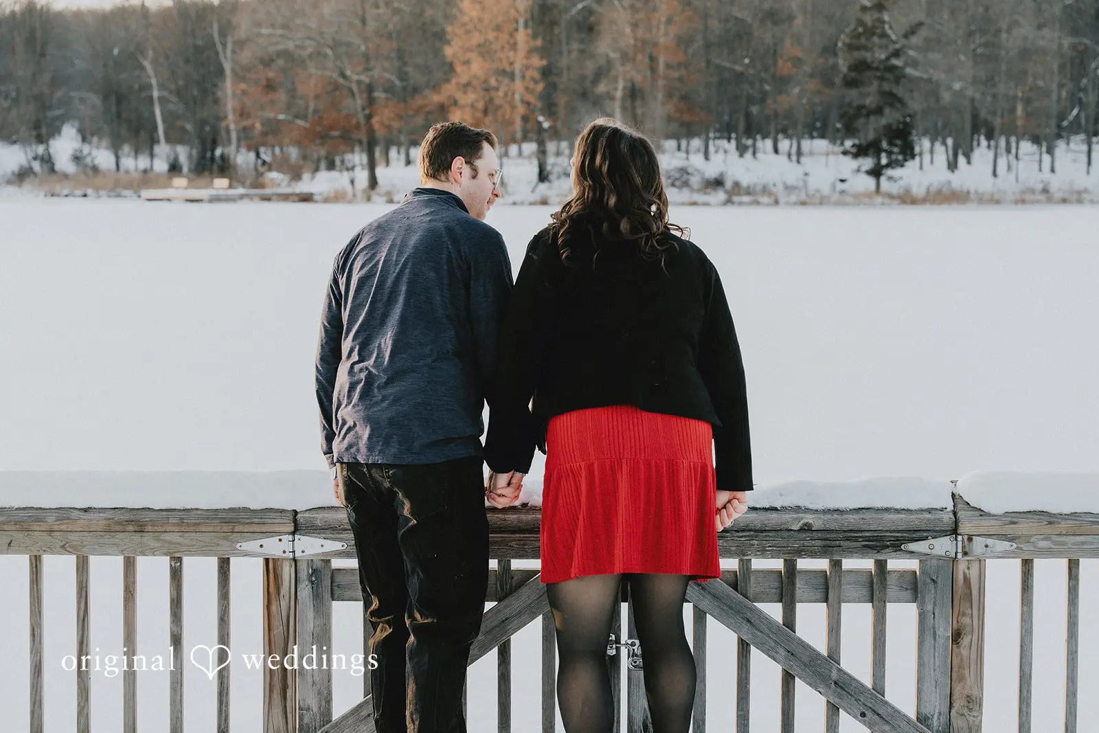 A portrait of the couple looking at the water