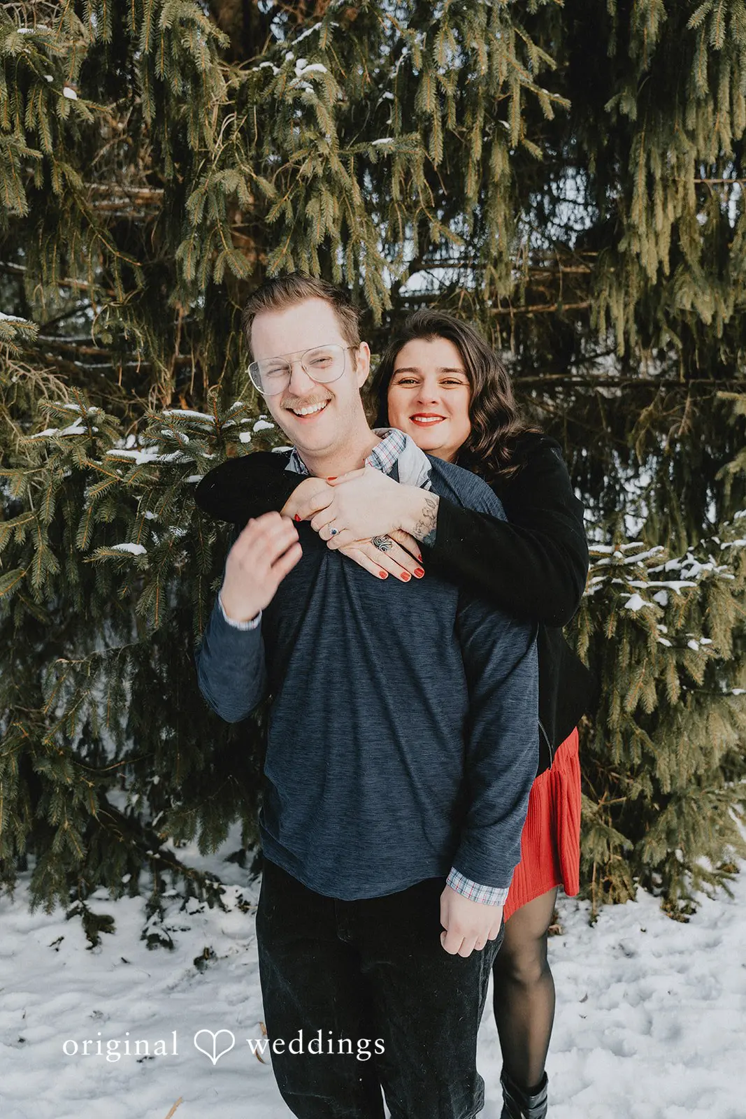 A romantic portrait of the couple in the snowy environment of Independence Oaks