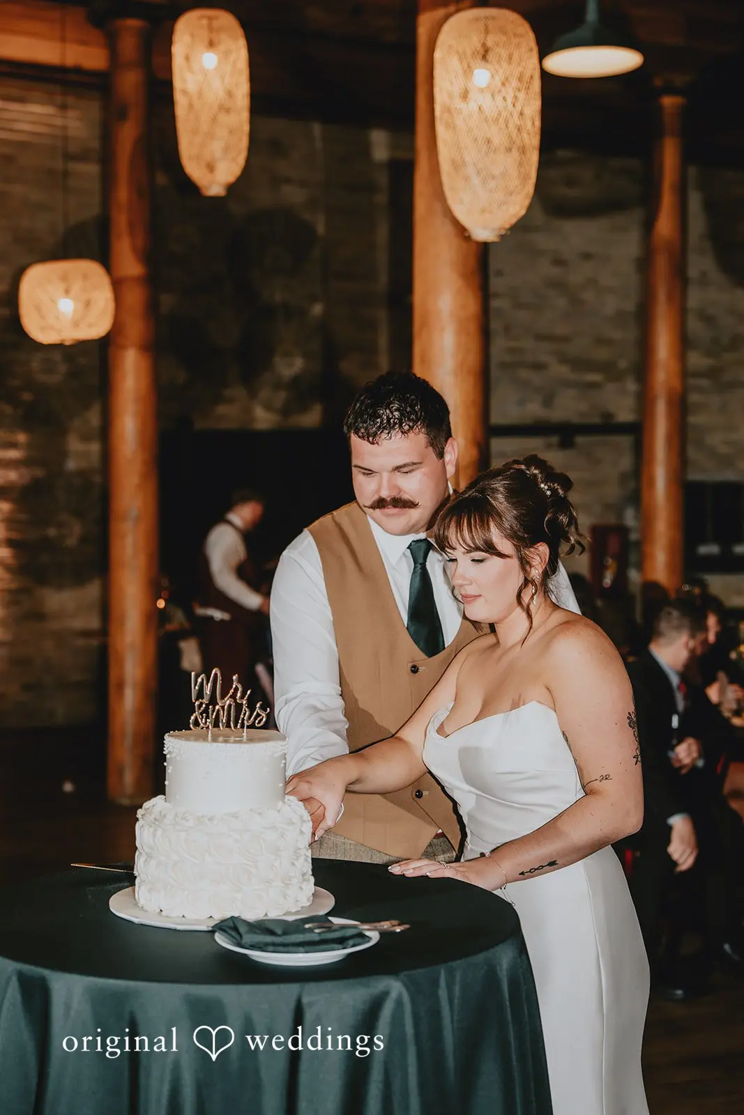 Hayden + Abby Beautiful portrait of the bride and groom cutting their wedding cake at Pritzlaff Events reception