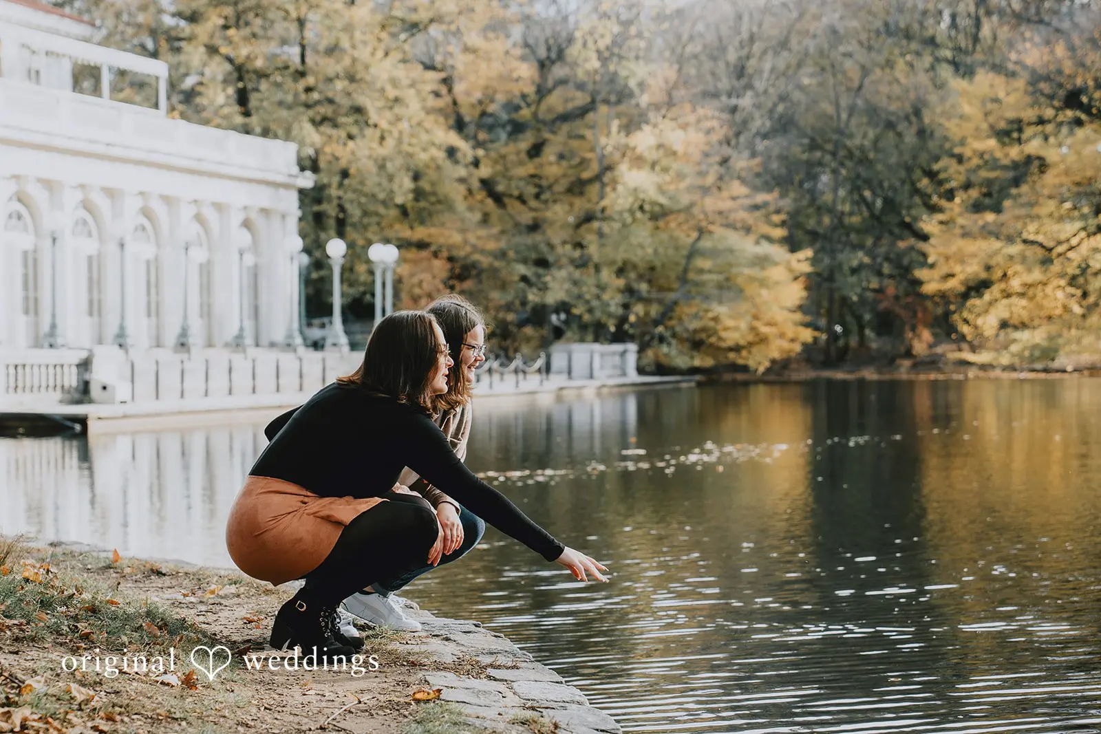 A fun portrait of Alexis and Molly by the water's edge