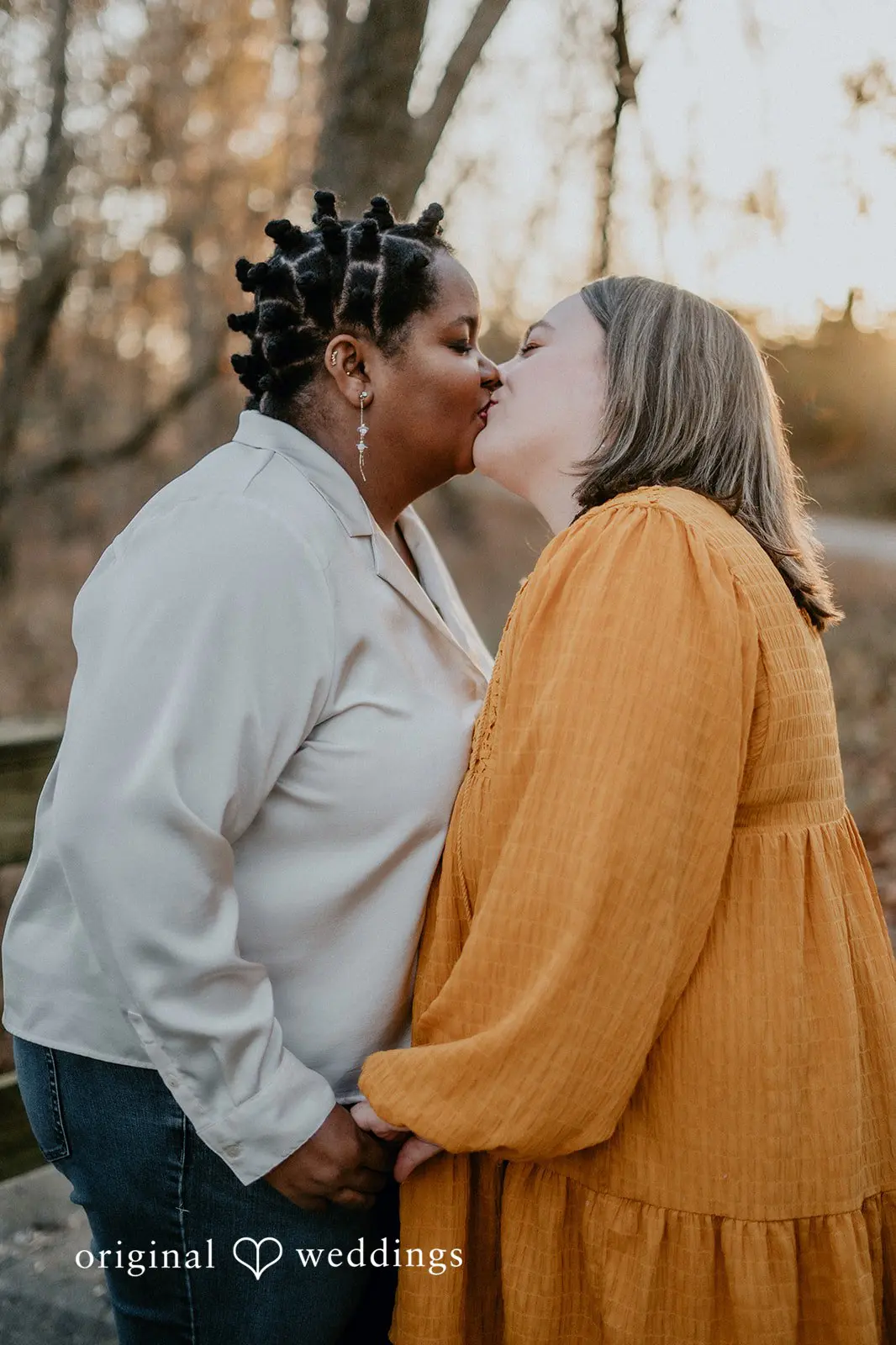 A portrait of the couple sharing a kiss at Queeny Park