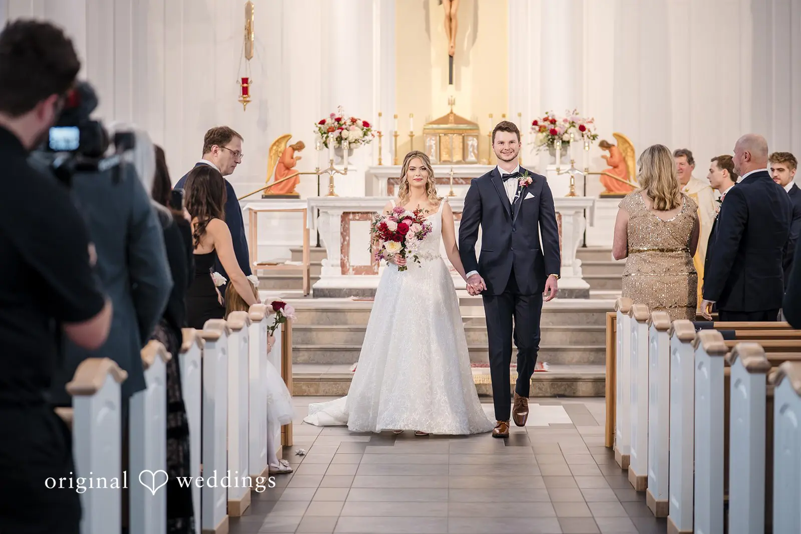 The bride and groom exiting the hall after their wedding ceremony