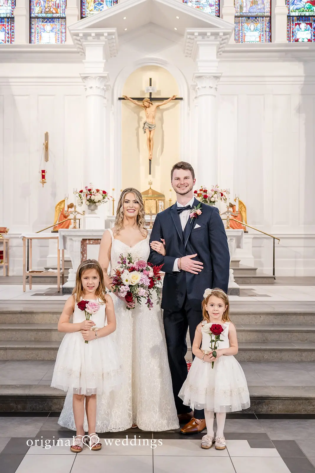 A portrait of the bride and groom with their flower girls