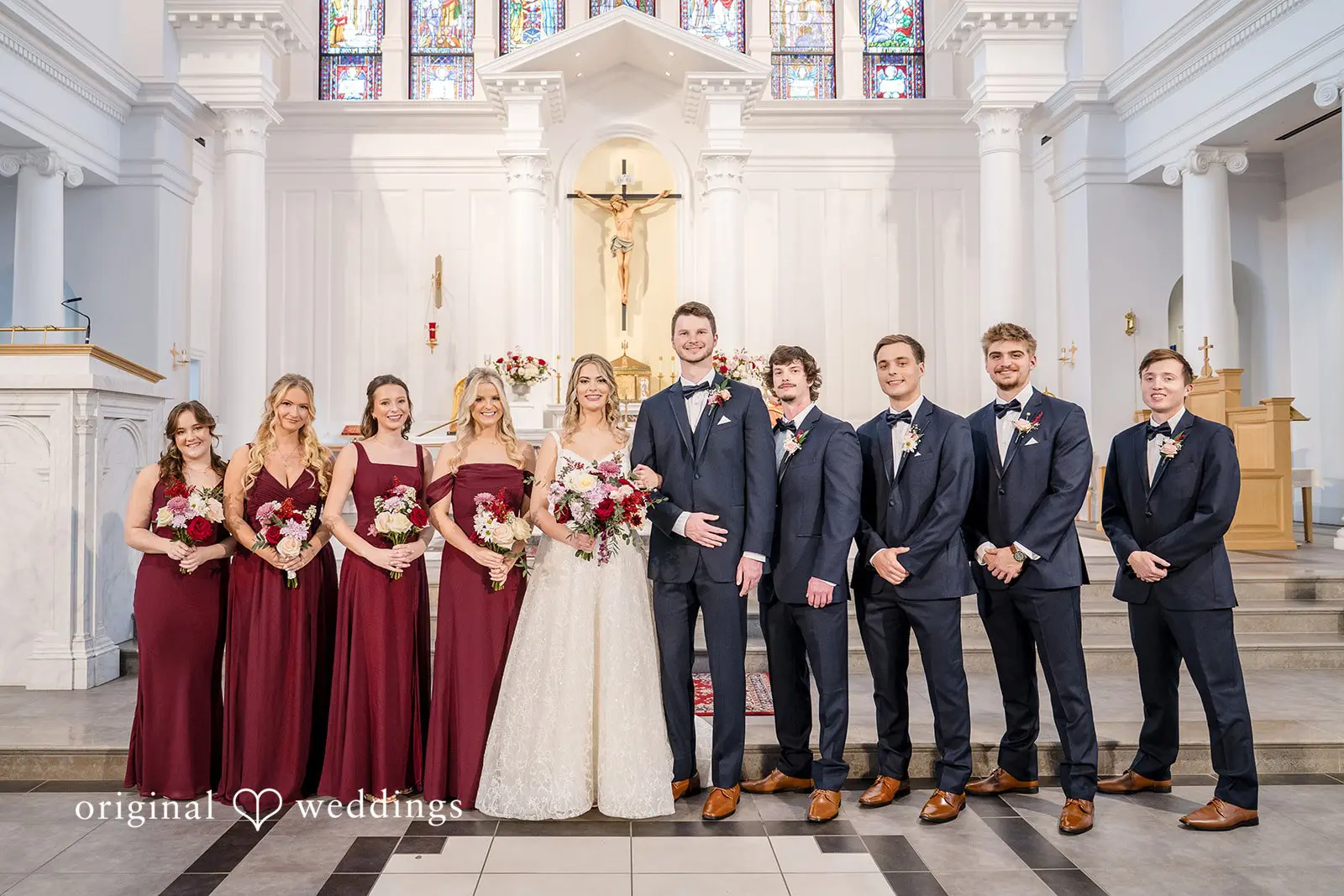 A portrait of the couple with their bridal party at Saint Mary of Sorrows Catholic Church