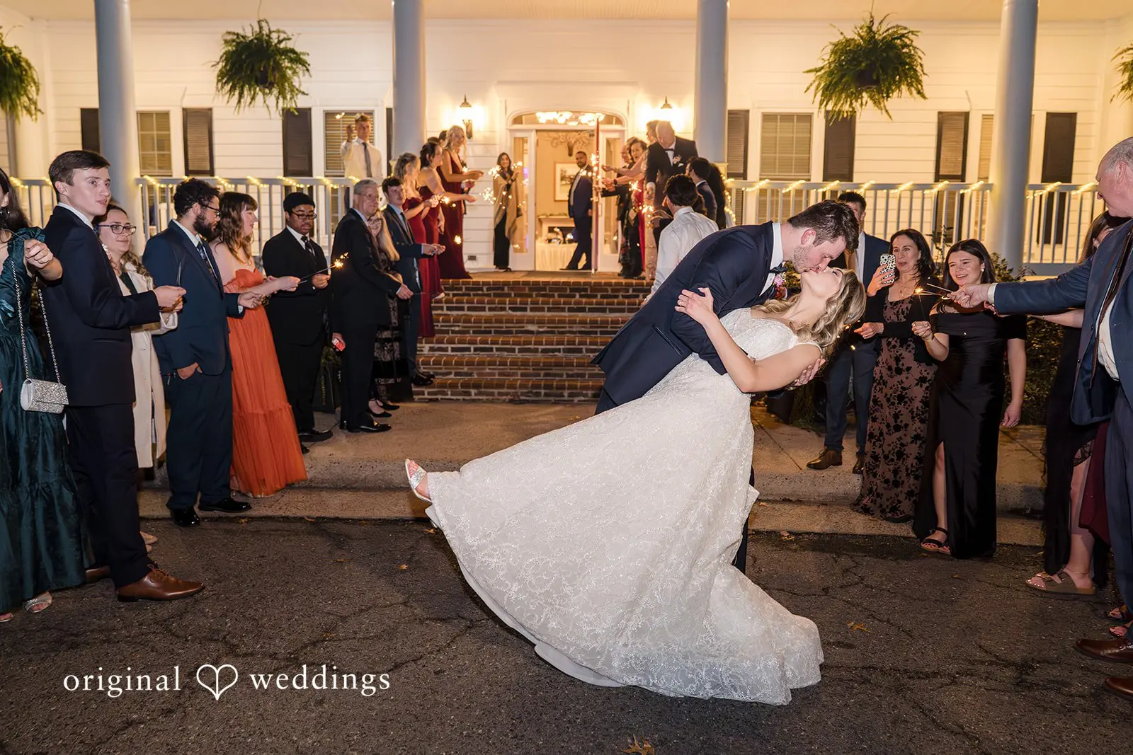 The bride and groom take a romantic kiss to seal the night